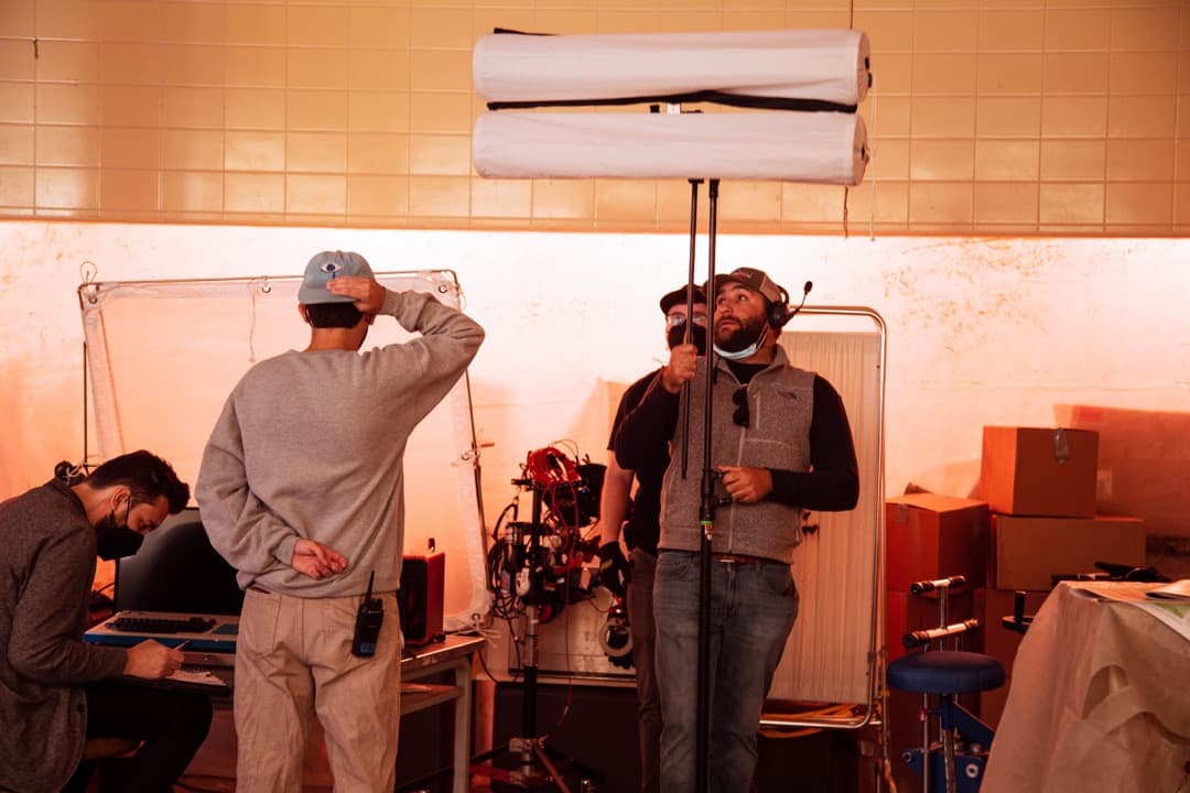 Behind the scenes photo 58 from Clone Cops production showing gaffer barrett dennison and best boy electric jarrett jarvis prepare for a scene